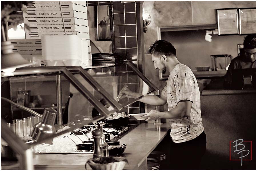 Guy choosing food at the salad bar 