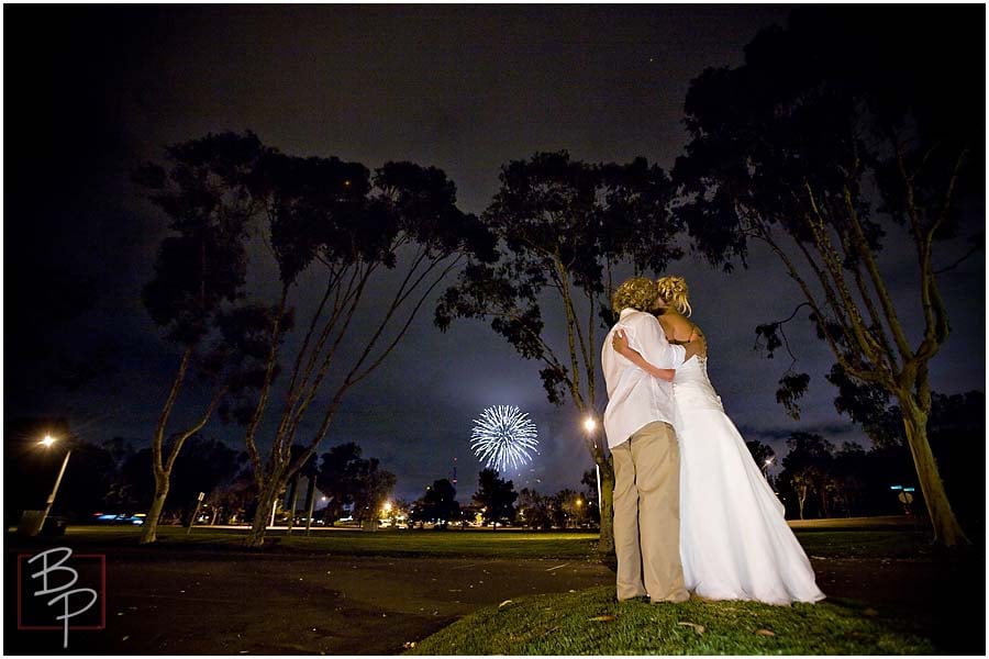 The bride and groom watching fireworks together