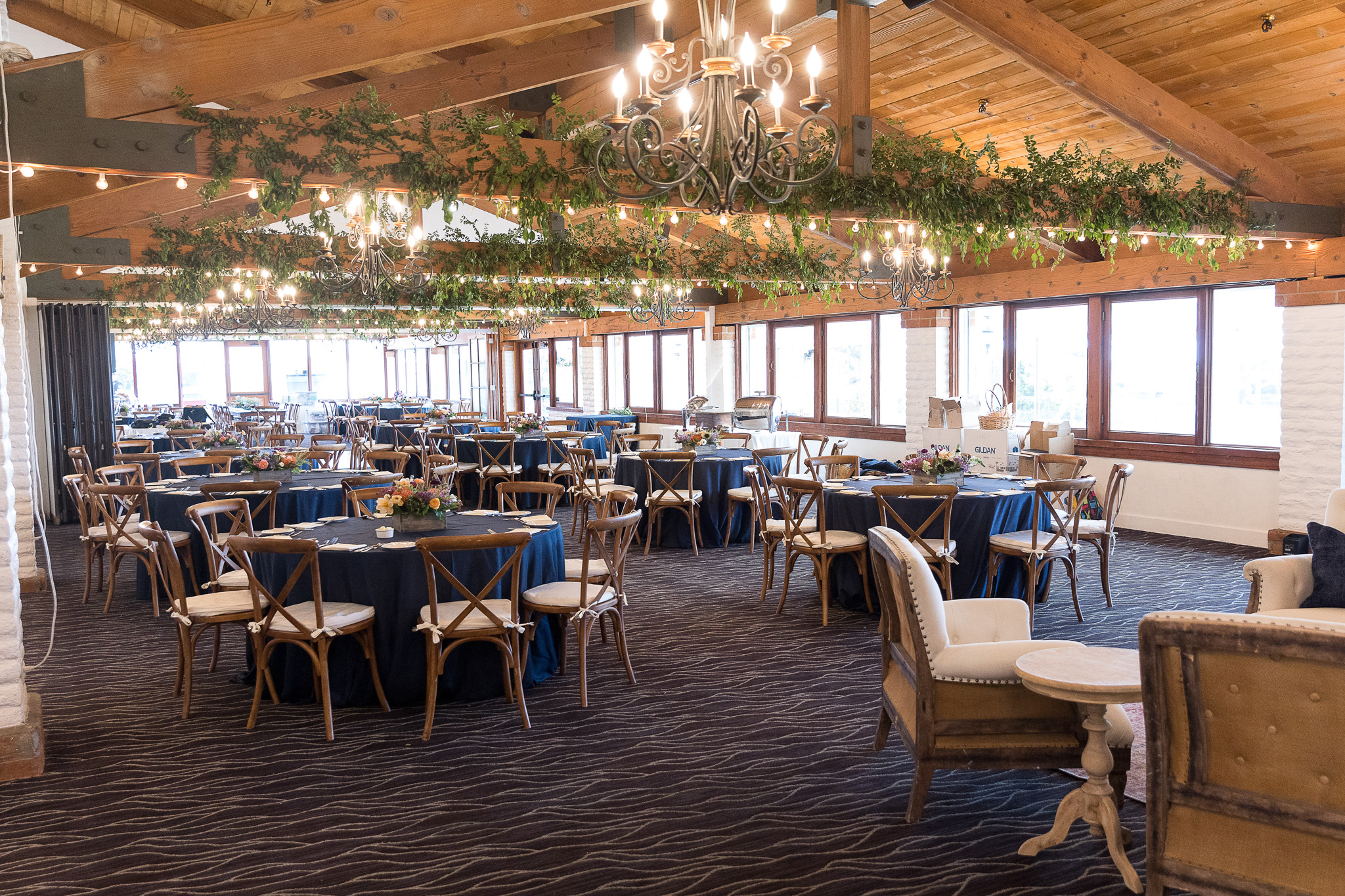A spacious banquet room featuring multiple tables and chairs arranged for dining or events