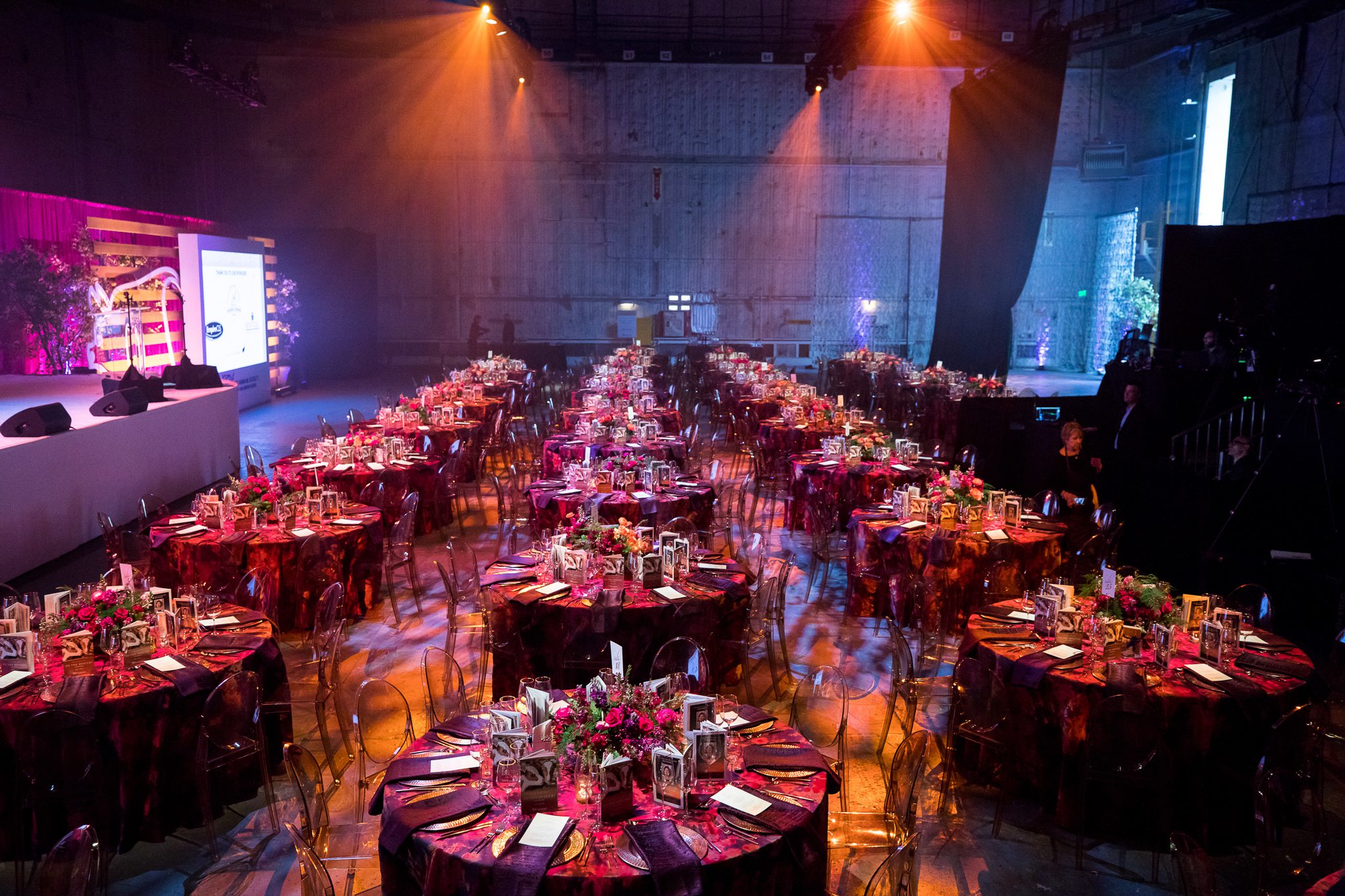 A large party room featuring multiple tables and chairs set up for guests to enjoy