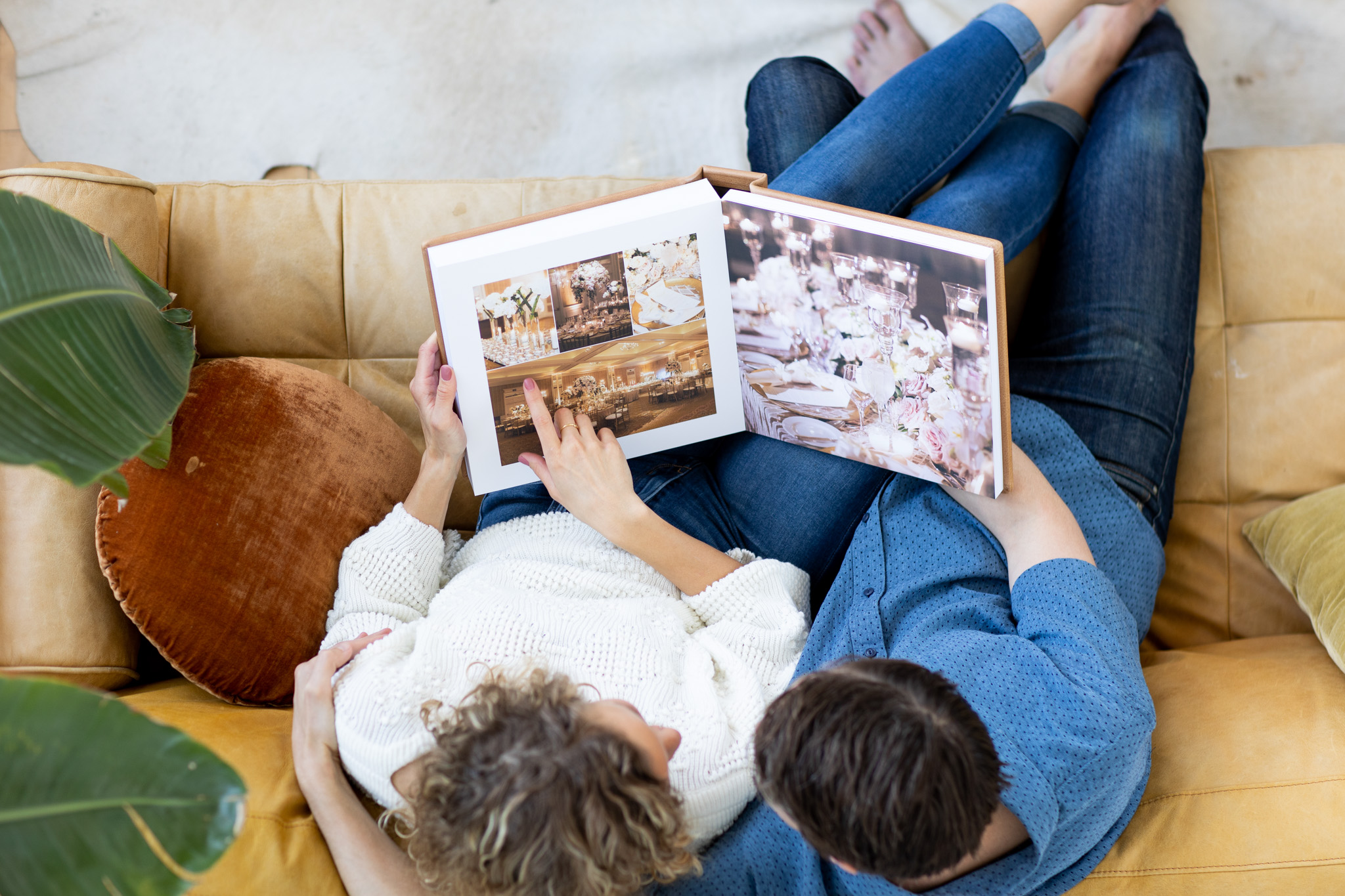 Couple looking through a photo album on a couch