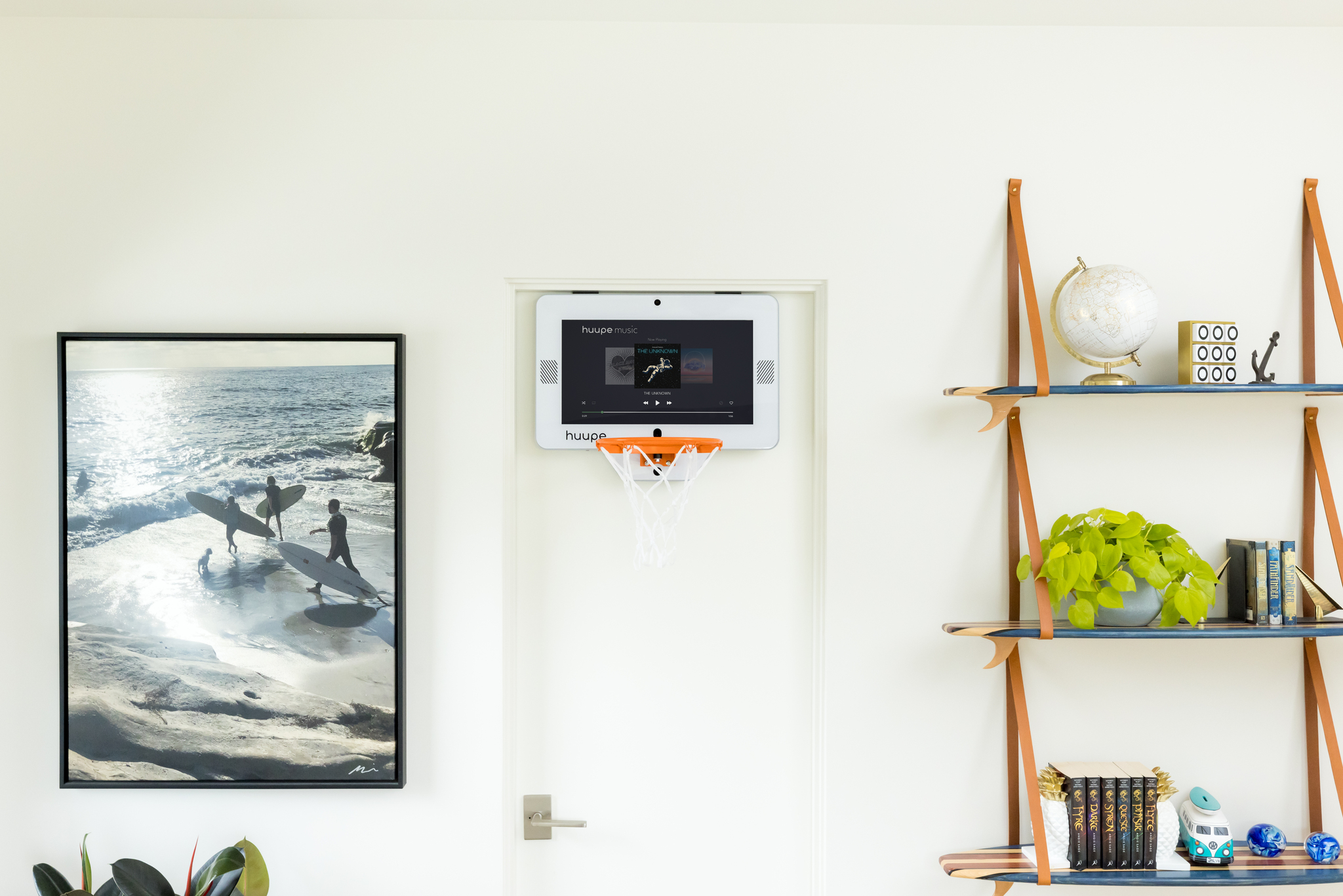 Wall-mounted music player with basketball hoop in a styled room