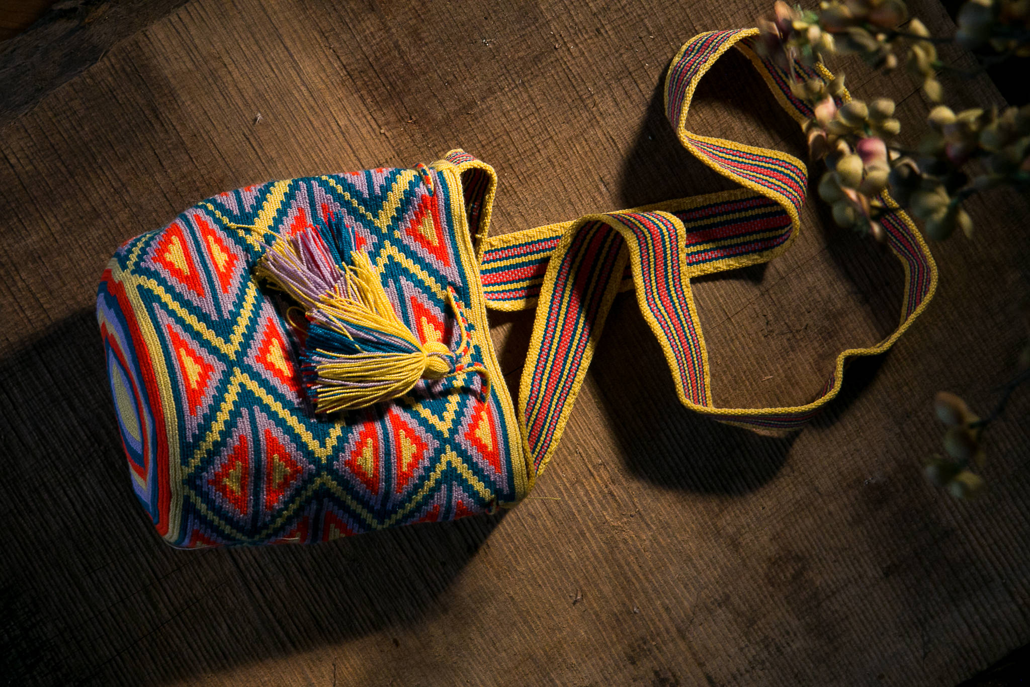 Colorful woven shoulder bag photographed for a product listing