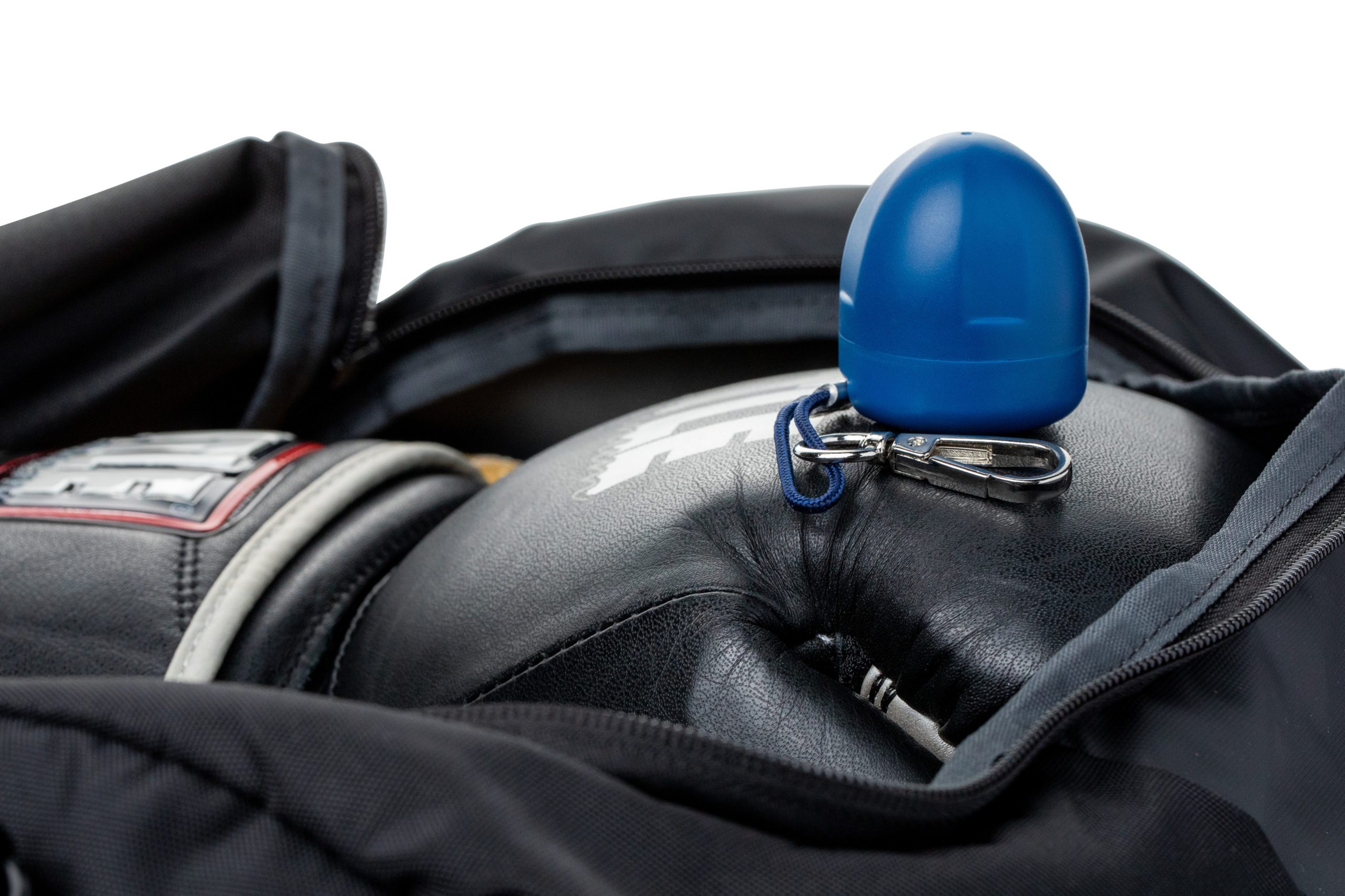 Blue keychain clipped onto boxing gloves inside a bag